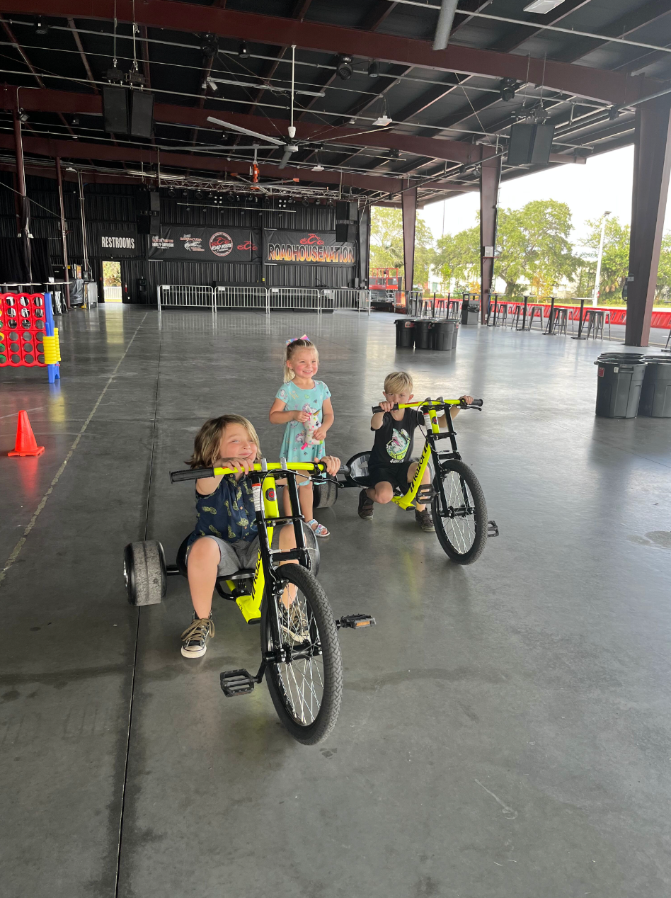young children riding mini trikes