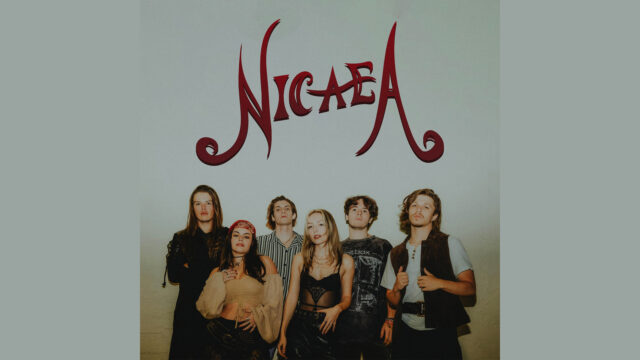 Six people stand posing in front of a white background with the word 